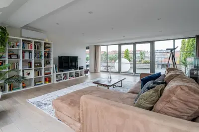 a living room with a couch and a tv at Domillion Amazing 3bdr Penthouse with Terrace MZ28 in Vilnius