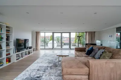 a living room with a brown couch and a television at Domillion Amazing 3bdr Penthouse with Terrace MZ28 in Vilnius