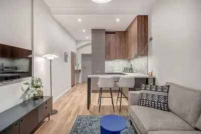 a living room and kitchen with a couch and a table at Domillion 1bdr Modern Old Town Retreat So1a in Vilnius