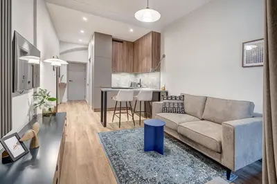 a living room with a couch and a kitchen at Domillion 1bdr Modern Old Town Retreat So1a in Vilnius