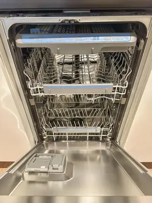 a dishwasher with a dish rack in it at Domillion 1bdr Modern Old Town Retreat So1a in Vilnius
