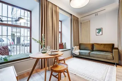 a living room with a couch and a table at Domillion Studio Modern Old Town Retreat So1c in Vilnius