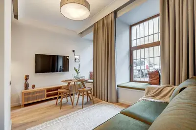a living room with a couch and a table at Domillion Studio Modern Old Town Retreat So1c in Vilnius