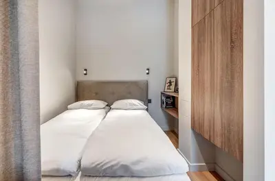 a bed with white sheets and pillows in a room at Domillion Studio Modern Old Town Retreat So1c in Vilnius
