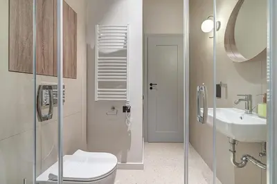 a bathroom with a toilet and a sink at Domillion Studio Modern Old Town Retreat So1c in Vilnius
