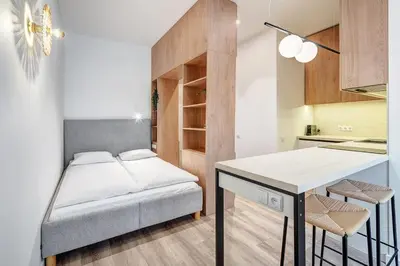 a small apartment with a bed and a desk in a room at Domillion Studio Modern Old Town Retreat So1b in Vilnius
