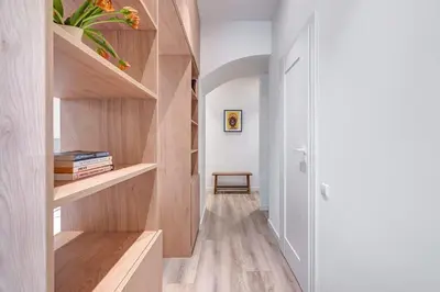 a hallway with wooden shelves in a house at Domillion Studio Modern Old Town Retreat So1b in Vilnius