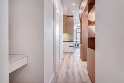 a kitchen with white walls and a wooden floor at Domillion Studio Modern Old Town Retreat So1b in Vilnius