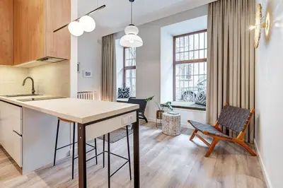 a kitchen with a table and chairs in a room at Domillion Studio Modern Old Town Retreat So1b in Vilnius