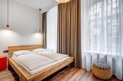 a bedroom with a bed and a large window at Domillion 2bdr Modern Old Town Retreat So1d in Vilnius