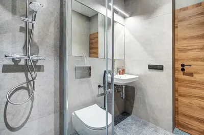 a bathroom with a shower and a toilet and a sink at Domillion 2bdr Modern Old Town Retreat So1d in Vilnius