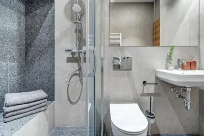 a bathroom with a shower and a toilet and a sink at Domillion 5bdr Modern Urban Fourplex So1F in Vilnius