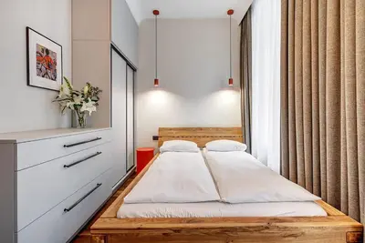 a small bedroom with a bed and a window at Domillion 5bdr Modern Urban Fourplex So1F in Vilnius