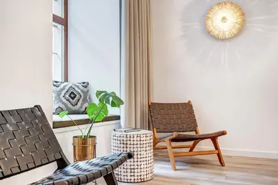 a living room with two chairs and a plant at Domillion 5bdr Modern Urban Fourplex So1F in Vilnius