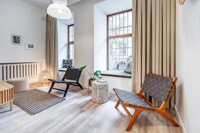 a living room with two chairs and a table at Domillion 5bdr Modern Urban Fourplex So1F in Vilnius