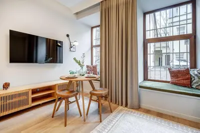 a living room with a table and a large window at Domillion 5bdr Modern Urban Fourplex So1F in Vilnius