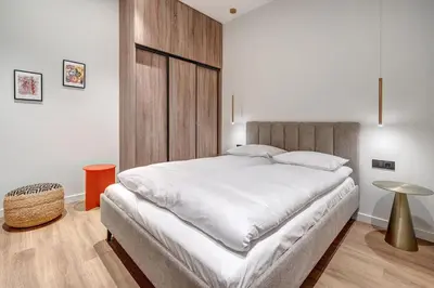 a bedroom with a large white bed and a table at Domillion 5bdr Modern Urban Fourplex So1F in Vilnius