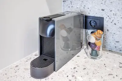 a toaster oven sitting on a counter next to a glass container at Domillion 5bdr Modern Urban Fourplex So1F in Vilnius