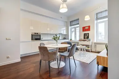 a kitchen and dining room with a table and chairs at Domillion 2bdr Bright&Central apt PA227 in Vilnius