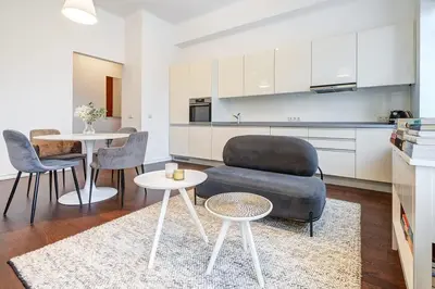 a living room with a couch and a table and chairs at Domillion 2bdr Bright&Central apt PA227 in Vilnius