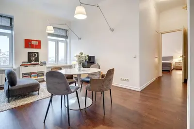 a living room with a dining room table and chairs at Domillion 2bdr Bright&Central apt PA227 in Vilnius