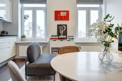 a kitchen with a dining room table and chairs at Domillion 2bdr Bright&Central apt PA227 in Vilnius