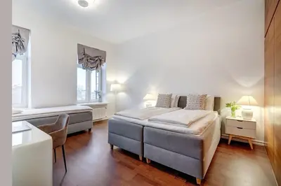 a bedroom with a bed and a chair in it at Domillion 2bdr Bright&Central apt PA227 in Vilnius