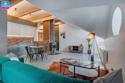 a living room with a couch and a table at Domillion Pylimo Penthouse duplex apt 15ppl P36D in Vilnius