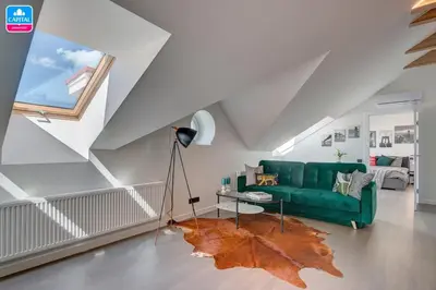 a living room with a green couch and a leaf rug at Domillion Pylimo Penthouse duplex apt 15ppl P36D in Vilnius