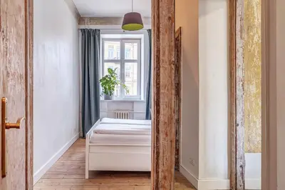 a mirror in a room with a bed and a window at Domillion Penthouse Duplex w Terrace 18 ppl P36T in Vilnius