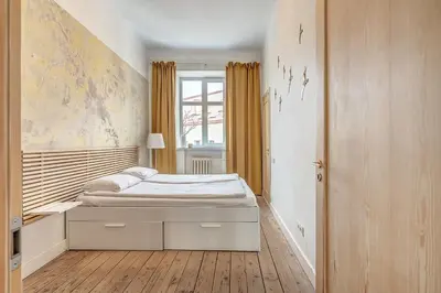a bedroom with a bed and a window in it at Domillion Penthouse Duplex w Terrace 18 ppl P36T in Vilnius