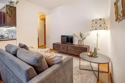 a living room with a couch and a table at Domillion Cozy 2bdr apt on Stikliu str S43 in Vilnius