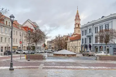 a city street with buildings and a clock tower at Domillion Cozy 2bdr apt on Stikliu str S43 in Vilnius