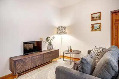 a living room with two couches and a flat screen tv at Domillion Cozy 2bdr apt on Stikliu str S43 in Vilnius