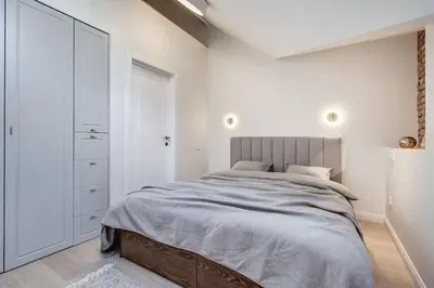 a bedroom with a large bed and a closet at Domillion oldtown new 5bdr 3bath apt P492a in Vilnius