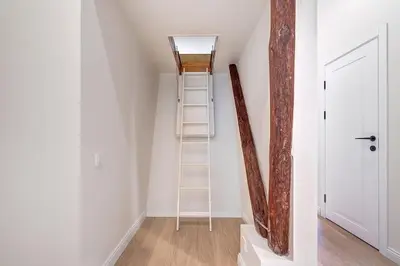 a ladder in the corner of a room with a stair case at Domillion oldtown new 5bdr 3bath apt P492a in Vilnius