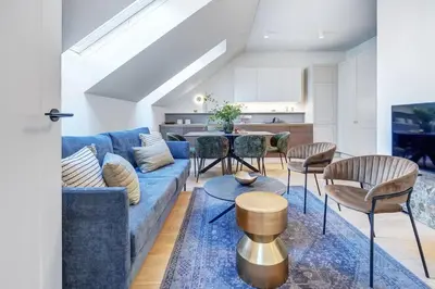 a living room with a blue couch and chairs at Domillion oldtown new 5bdr 3bath apt P492a in Vilnius