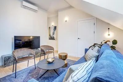 a living room with a blue couch and a table at Domillion oldtown new 5bdr 3bath apt P492a in Vilnius