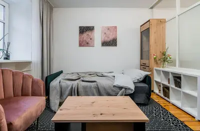 a living room with a bed and a coffee table at Domillion 1bdr Traku str apt&free parking Tr135 in Vilnius