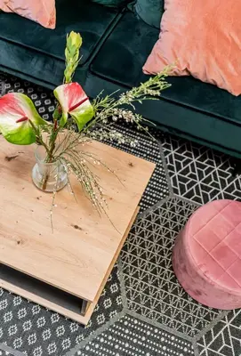 a wooden table with a vase with flowers on it at Domillion 1bdr Traku str apt&free parking Tr135 in Vilnius