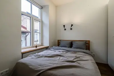 a bedroom with a bed and a window at Domillion 1bdr unique and warm Old Town apt Tr41 in Vilnius