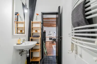 a bathroom with a sink and a mirror at Domillion 1bdr unique and warm Old Town apt Tr41 in Vilnius