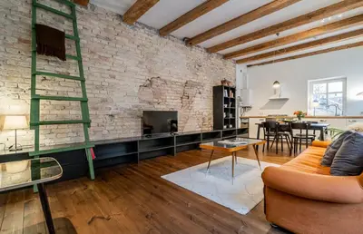 a living room with a brick wall at Domillion 1bdr unique and warm Old Town apt Tr41 in Vilnius