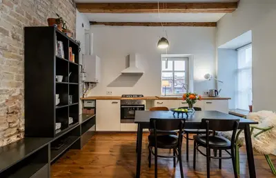 a kitchen with a table and chairs in a room at Domillion 1bdr unique and warm Old Town apt Tr41 in Vilnius