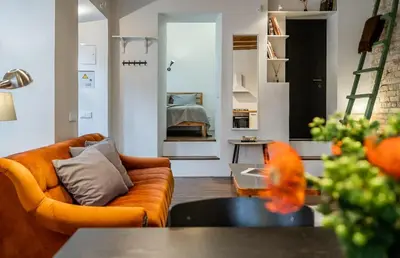 a living room with a couch and a table at Domillion 1bdr unique and warm Old Town apt Tr41 in Vilnius