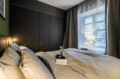 a bedroom with a large bed with a window at Domillion 1bdr brand-new Uzupis apt w free parking in Vilnius