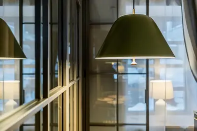 a green lamp sitting in front of a window at Domillion 1bdr brand-new Uzupis apt w free parking in Vilnius
