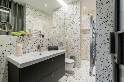 a bathroom with a sink and a toilet at Domillion 1bdr brand-new Uzupis apt w free parking in Vilnius