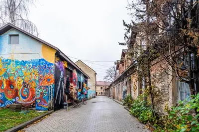 an alley with graffiti on the side of a building at Domillion 1bdr brand-new Uzupis apt w free parking in Vilnius