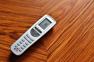 a remote control sitting on top of a wooden table at Domillion New Modern Old town apt 16 ppl U2C1 in Vilnius
